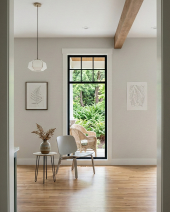 Professional painter applying white paint to a residential interior wall with a roller.